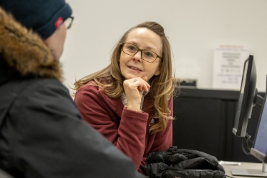 Professor speaking with student in class
