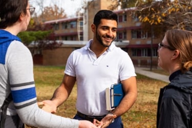 SIUC student talking to other students on campus